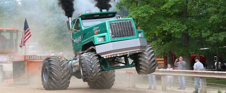Green Ghost monster truck popping a wheelie
