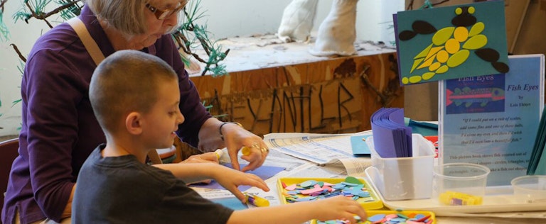 Grandmother with their son doing learning activities