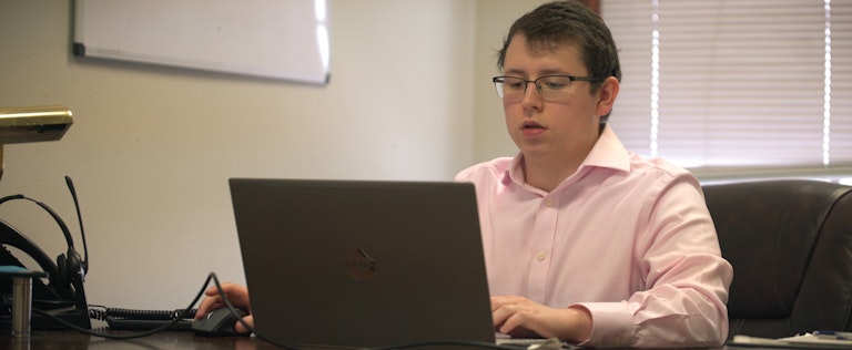 Working on a laptop with Nextiva