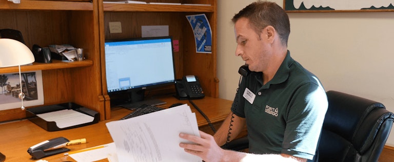 Staff memmber at Point Sebago taking a phone call