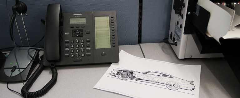 Panasonic phone next to a Shelby concept drawing